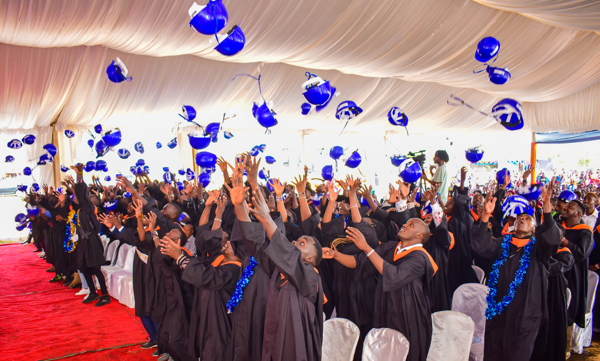 Graduates celebrating with balloons at graduation ceremony