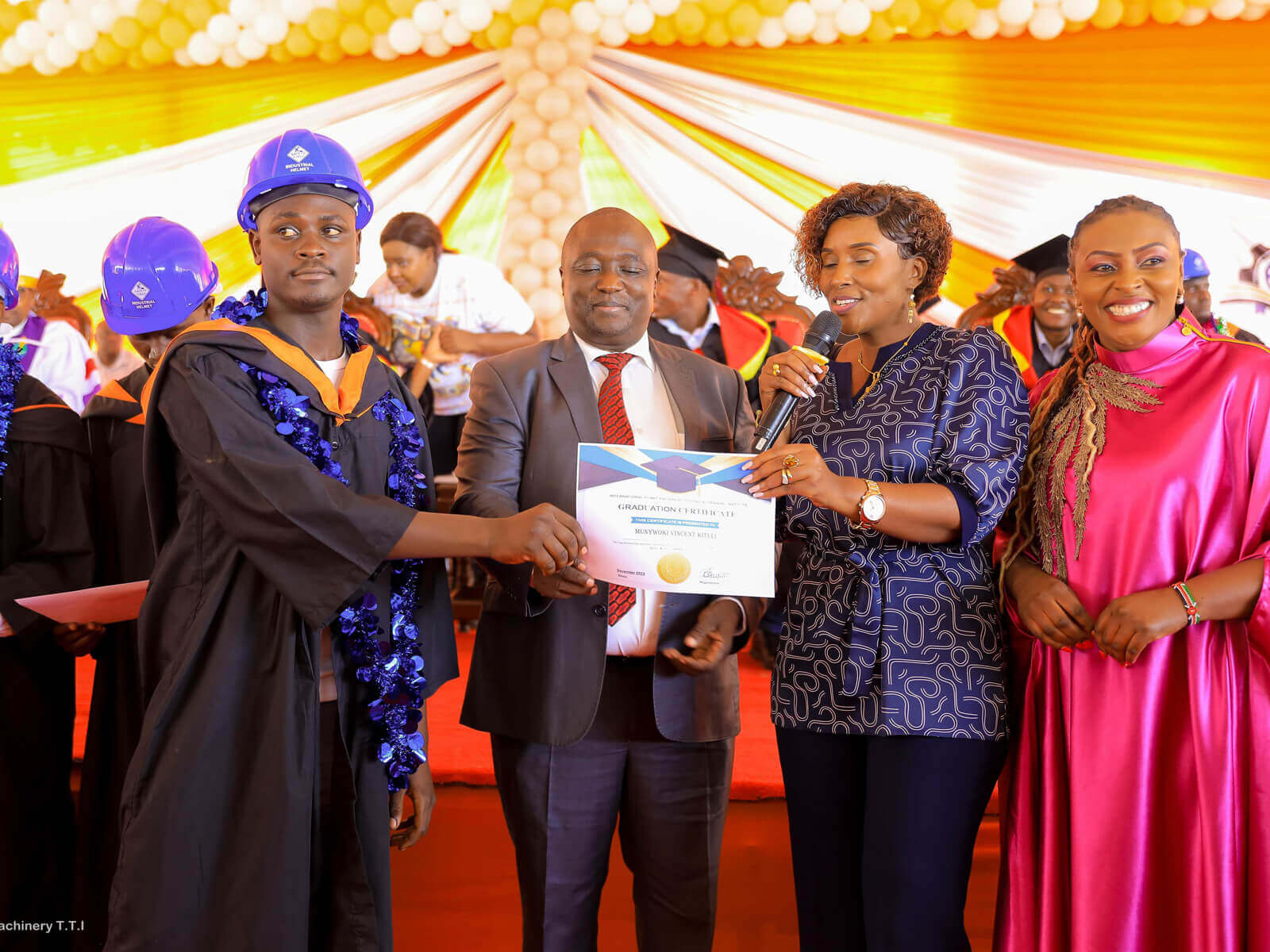 Graduate receiving certificate during graduation ceremony